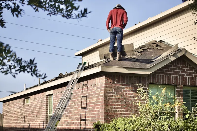 Professional roofer working on a residential roof in Sterling Park